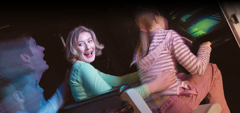 A family taking a ride on Explorer 1 Simulator
